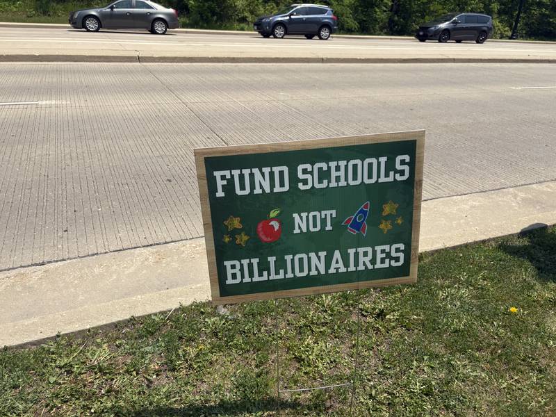 A sign reading "Fund Schools Not Billionaires" lines Route 47 in Huntley May 31, 2025.