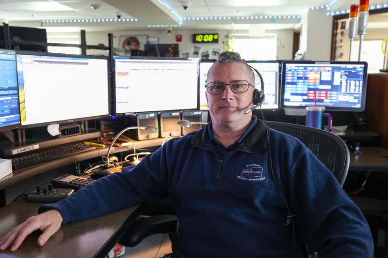 Marc Cote, a KanComm telecommunicator since 2005, sits as his station at the Kankakee dispatch headquarters on April 22, 2026.