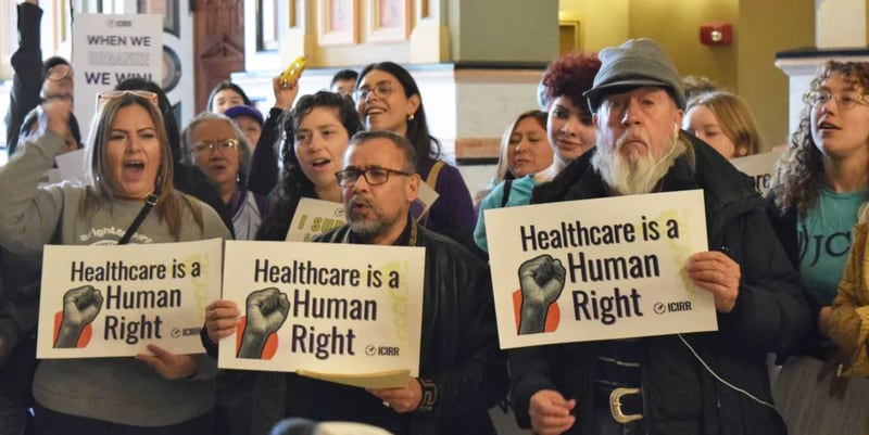 A crowd gathers at the Illinois Capitol in February to urge state lawmakers to continue to support pro-immigrant policies, including Illinois’ programs for noncitizen health care. Gov. JB Pritzker’s administration has proposed cutting one of the programs.