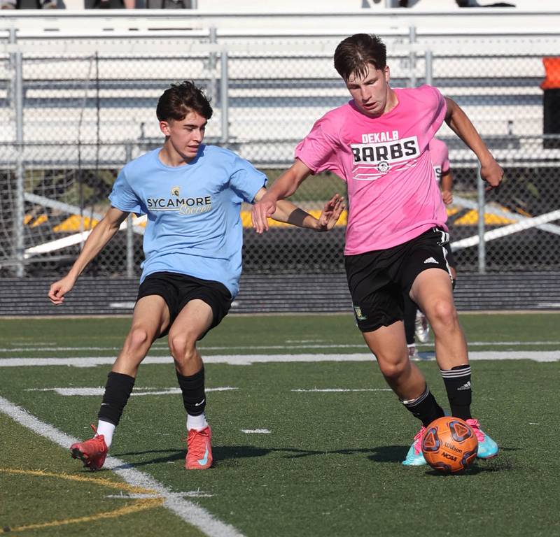 DeKalb’s Jack McCormick works to get by a Sycamore player Monday, July 14, 2025, during a summer boys soccer friendly at DeKalb High School.