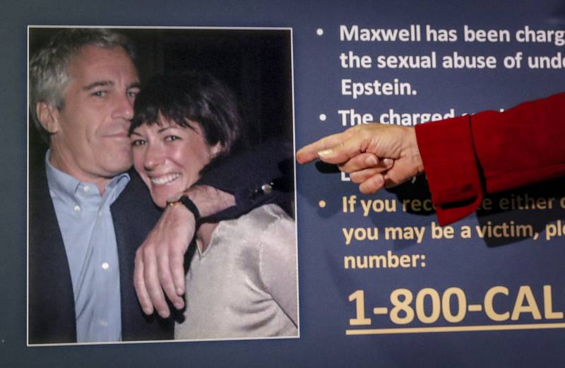 FILE - In this July 2, 2020, file photo, Audrey Strauss, acting U.S. attorney for the Southern District of New York, points to a photo of Jeffrey Epstein and Ghislaine Maxwell during a news conference in New York. Maxwell, a British socialite charged with recruiting girls for financier Epstein to sexually abuse in the 1990s, is asking a judge to dismiss the case on multiple grounds. A trial is scheduled for July 2021. (AP Photo/John Minchillo, File)