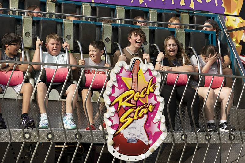 Riders hang on while soaring on the Rock Star Wednesday, July 3, 2024 at the Petunia Fest carnival.