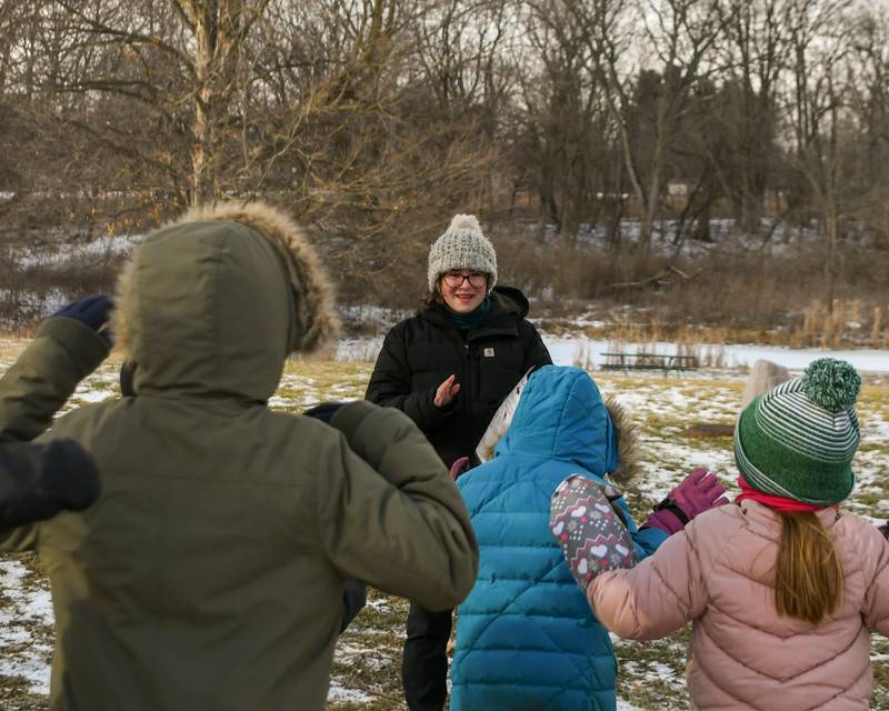 St. Charles East freshman Shae Besch guides participants to see how fast they can flap their arms compared to a brown bat. It was part of Polar-Palooza Saturday Jan. 17, 2026, held at Creek Bend Nature Center in St. Charles.