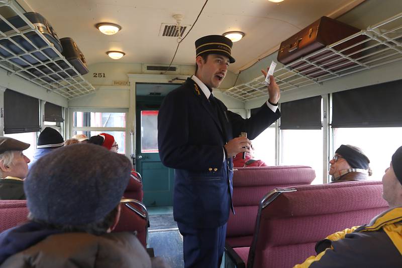 Conductor Ryan Daleen punches tickets as people ride on a North Shore train Saturday, Jan. 21, 2023, as the Illinois Railway Museum celebrates its 70 anniversary with the first of many celebrations by commemorating the 60 years since the abandonment of the Chicago North Shore and Milwaukee Railroad.