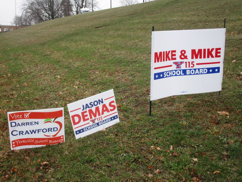 Campaign signs for Yorkville School District Y115 Board of Education candidates.