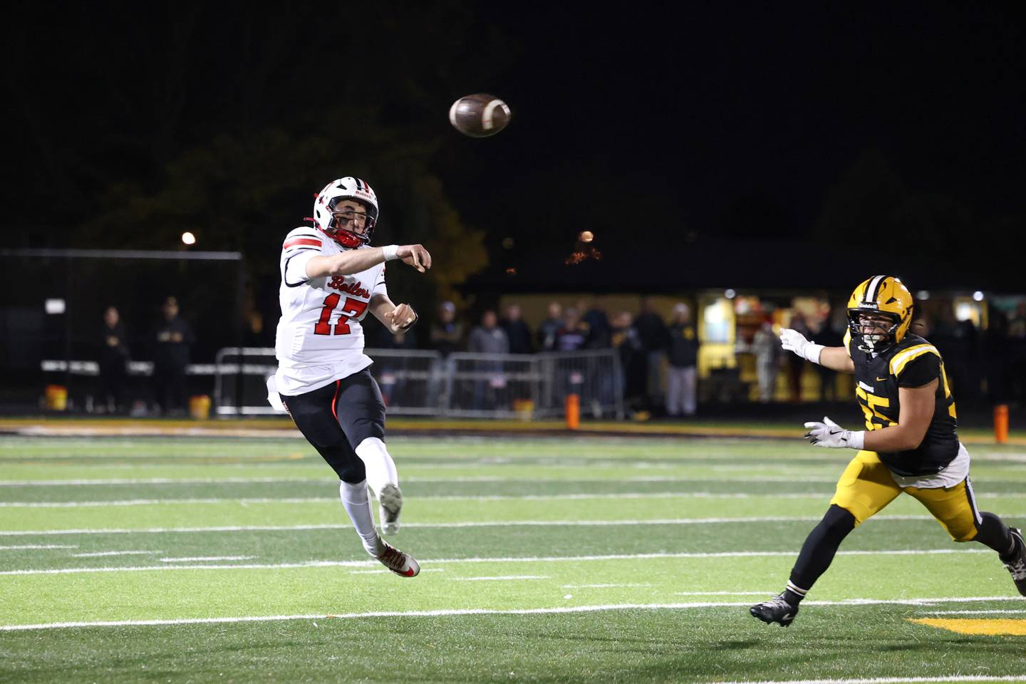 Bradley-Bourbonnais' Ellis Johnson throws the ball as St. Laurence's Brian Killen closes in during the Vikings 35-21 victory over Bradley-Bourbonnais in second round playoff on Friday, Nov. 7, 2025.
