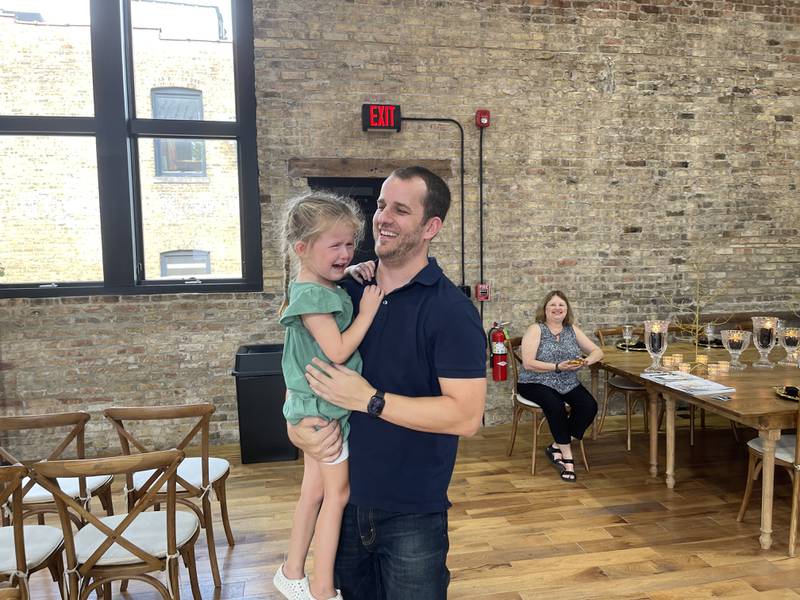 Derek Biesinger consoles his daughter, Fallon after the two shared a dance on Saturday, Sept. 17, 2022 at The District in Richmond. The District, a new renovated venue out of Memorial Hall, celebrated its grand opening over the weekend as part of Richmond's 150th anniversary.