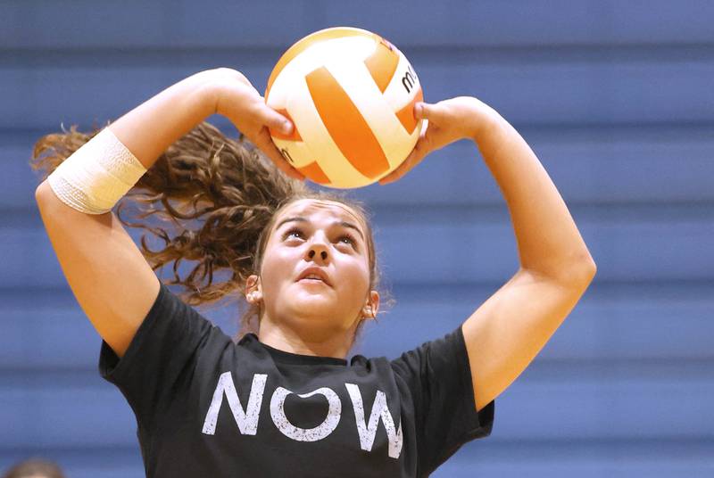 Genoa-Kingston's Alivia Keegan sets a ball Tuesday, Aug. 23, 2022, during volleyball practice at the school in Genoa.