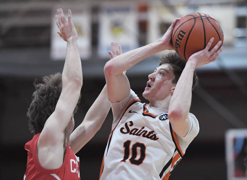 St. Charles East’s Steven Call shoots over Naperville Central’s Jonathan Boomgarden in a boys basketball game in St. Charles on Wednesday, January 25, 2023.