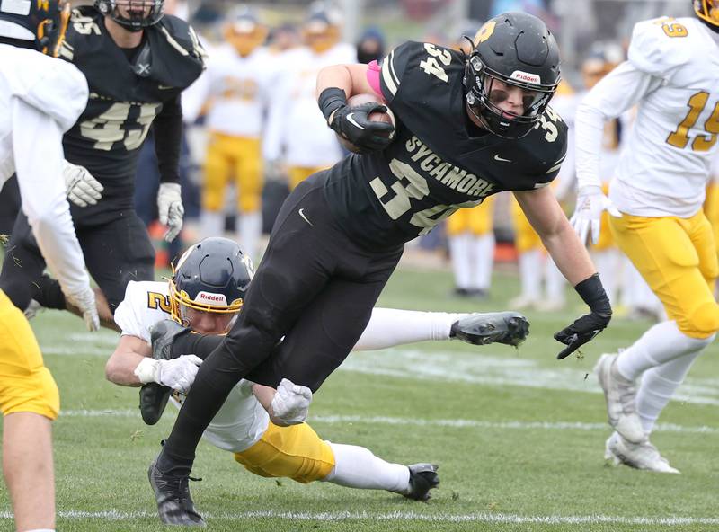 Sycamore's Joey Puleo escapes the tackle of Sterling's JP Schilling during their Class 5A state playoff game Saturday, Nov. 12, 2022, at Sycamore High School.