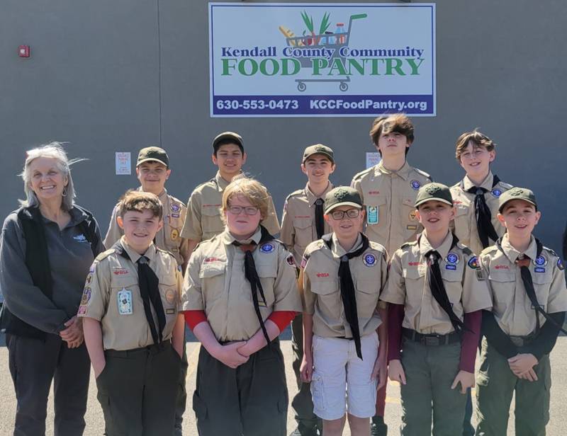 Suzanne Stegeman, executive director of the Kendall County Community Food Pantry, pictured left, accepts a donation of spaghetti dinner tickets from Yorkville Troop 40. The troop's fundraising dinner is set for Friday, April 14.