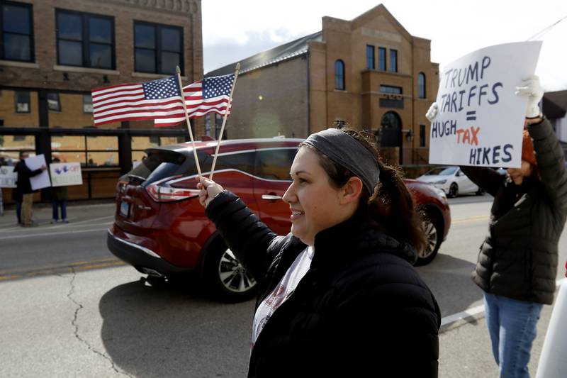 Protesters line U.S. Route 12 in Richmond to protest their discontent with President Donald Trump and his administration's policies on Saturday, April 19, 2025. Over 100, people took part in the Richmond protest. A second rally was held in Harvard later in the day.