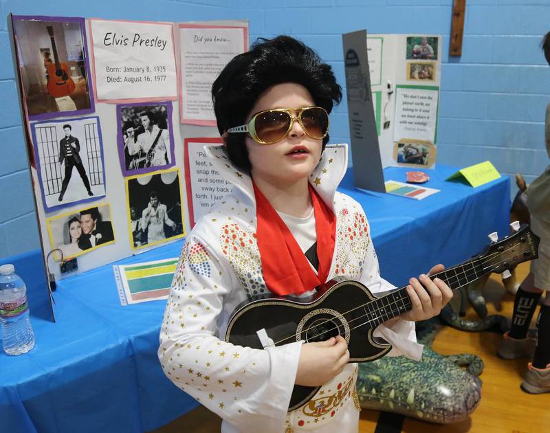 Third grader Chris Roche, who is portraying Elvis, gives his presentation during the Hinckley Big Rock Elementary School Wax Museum Thursday, March 13, 2025, at the school in Hinckley.