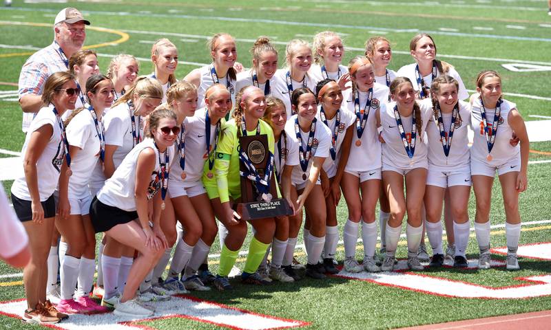 Crystal Lake Central poses with the championship trophy after defeating De La Salle in the IHSA girls Class 2A third-place soccer game at North Central College in Naperville on Saturday, June 3, 2023.