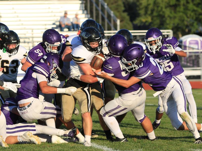 A host of Rochelle defenders bring down a Lena-Winslow ball carrier during their JV football game on Friday, Sept. 12, 2025.
