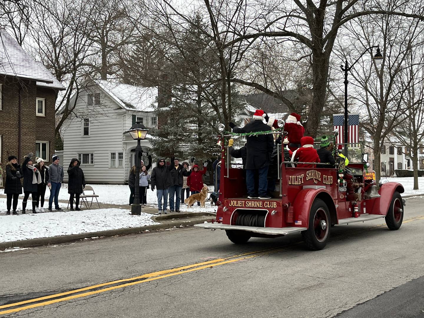 Santa Claus and Joliet city officials greet residents in Joliet on Saturday, Dec. 17, 2022, as part of the Santa Send-Off parade.