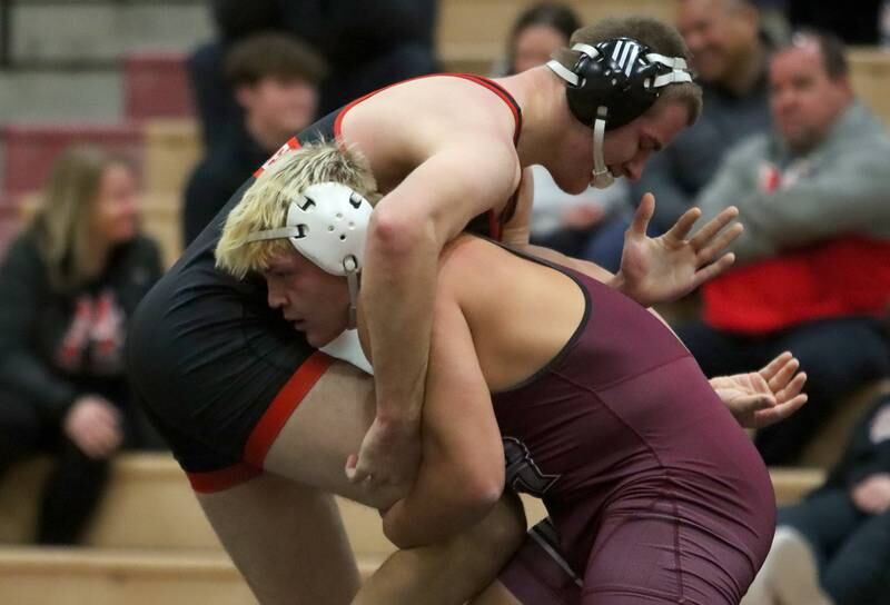 Huntley’s Wyatt Theobald, left, battles Prairie Ridge’s Walter Pollack at 215 pounds in varsity wrestling on Thursday, Jan. 23, 2025, at Huntley High School in Huntley.