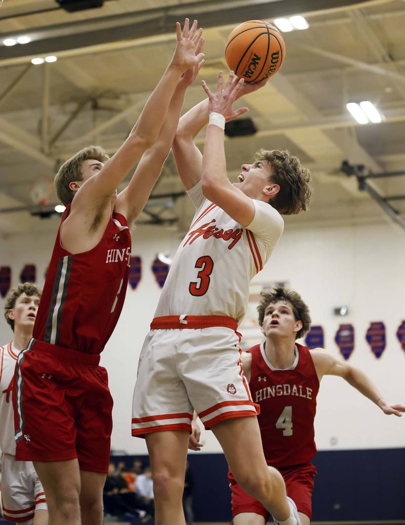 Hersey’s Charlie Pomis (3) shoots over Hinsdale Central’s Dillon Dell (3) Saturday, Jan. 4, 2025 in Buffalo Grove.