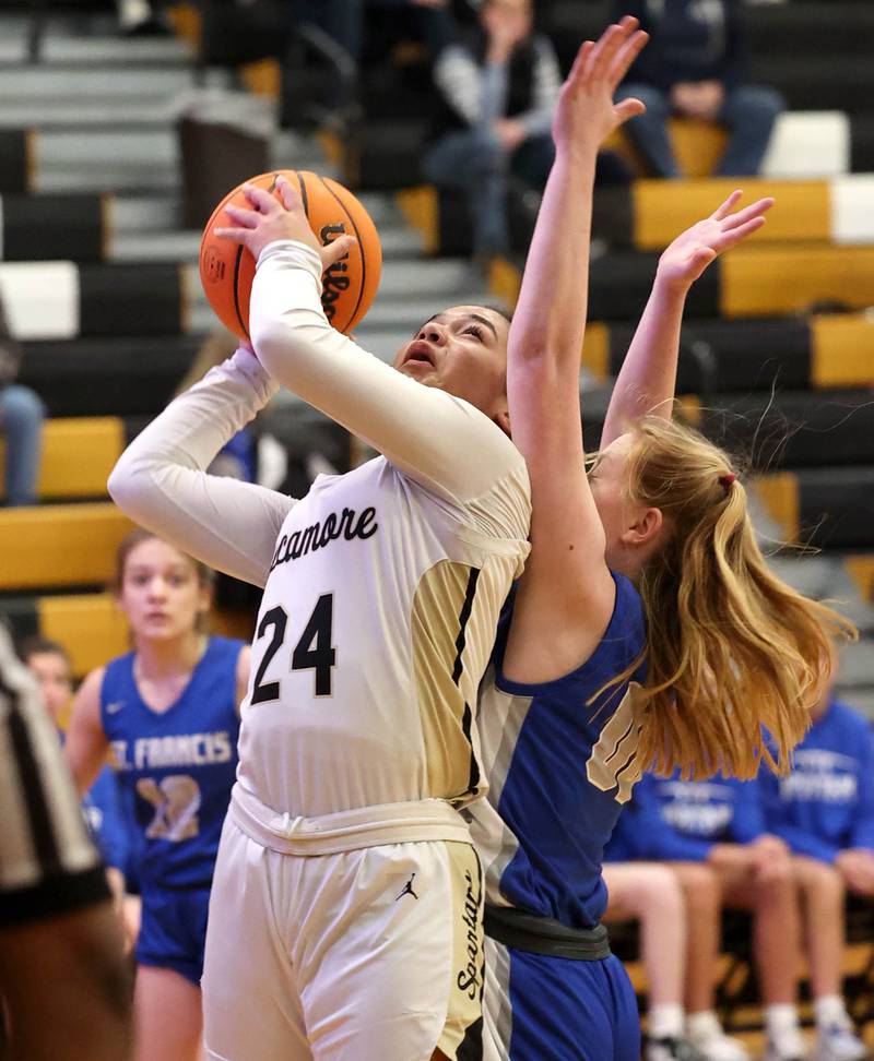 Sycamore's Monroe McGhee gets to the basket in front of St. Francis' Lynsey Cleveland during their game Thursday, Jan. 4, 2023, at Sycamore High School.
