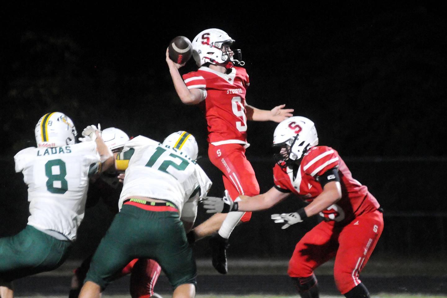 Streator quarterback Sam LeRette (9) attempts a pass with teammate Aiden Ferris blocking as Coal City's Donnie Ladas (8) and Emmett Easton (12) apply pressure Friday, Sept. 19, 2025, at Doug Dieken Stadium in Streator.