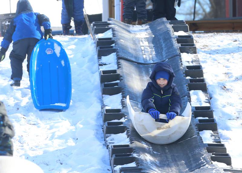 Jonas Karina of La Salle, slides down a toboggan run during the Lowaneu Cub Scout Yukon on Saturday, Jan. 31, 2026 at Hall Township Echo Bluff Park in Spring Valley.