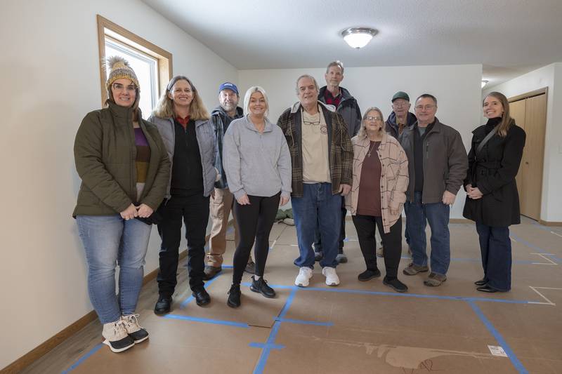 Dixon Habitat for Humanity board members surround Megin Steeb (middle) Sunday, Dec. 22, 2024, after the dedication of her new home.