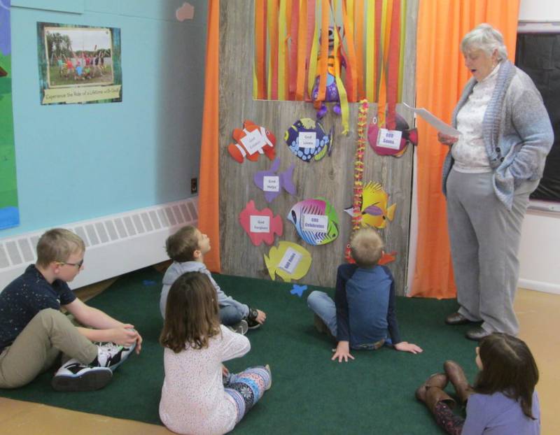 Pictured are Sunday School students  listening as teacher Gerri Henze shares a skit with Romper the Otter.