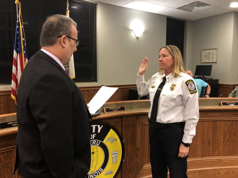 Peru Mayor Ken Kolowski swears in Sarah Raymond as the first female police chief in Peru and in La Salle County on Monday, Nov. 21, 2022.