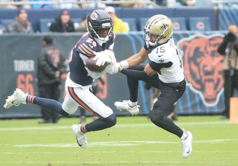 Chicago Bears wide receiver Devin Duvernay catches the ball on a return as teammate defensive back Jaylon Jones hold off New Orleans Saints defensive back Jordan Howden