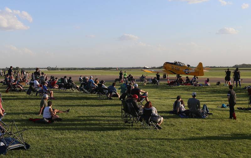 A large crowd gathers as a T-6 Texan departs during the 10th annual TBM Avenger Reunion and Airshow on Friday, May 16, 2025 at the Illinois Valley Regional Airport in Peru.