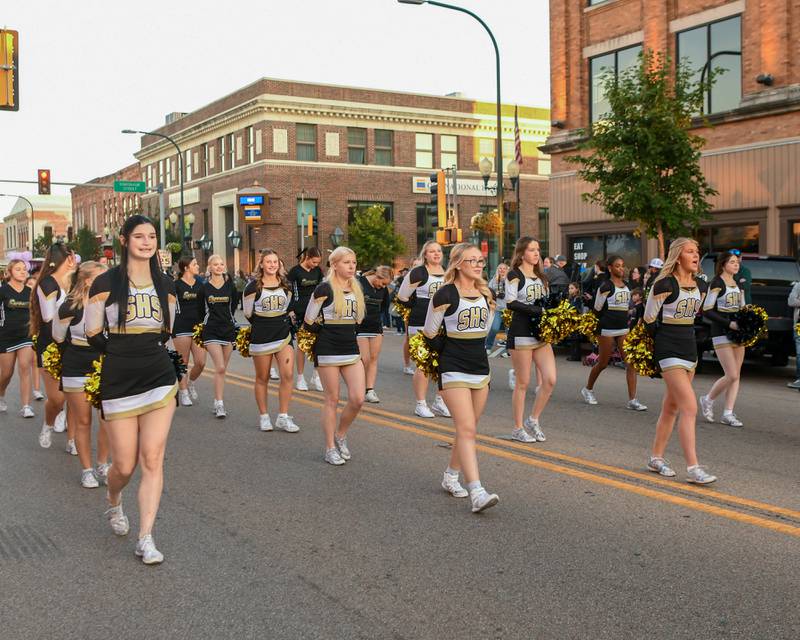 Sycamore High School’s cheer team is all smiles as members make their way through the Homecoming parade on Wednesday, Oct. 8, 2025, in downtown Sycamore.