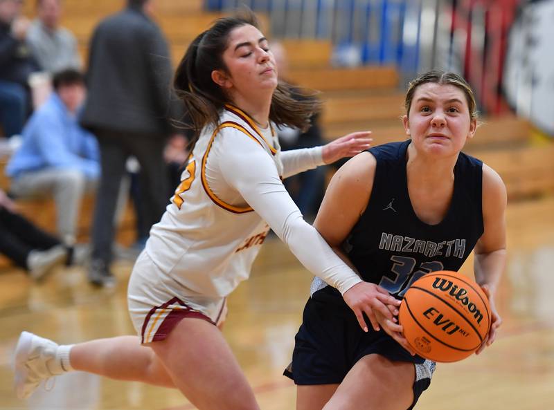 Nazareth’s Stella Sakalas drives past Montini’s Natalie Gartlan during a Coach Kipp Hoopsfest game on January 20, 2025 at Benet Academy in Lisle.