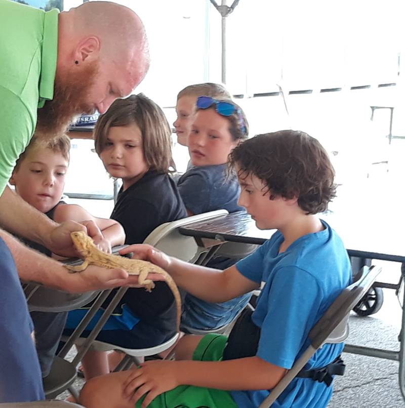 Bill Bradley of Coal Black Exotics lets children pet a bearded dragon Saturday, Aug. 6, 2022, at Shipyard Days in Seneca.