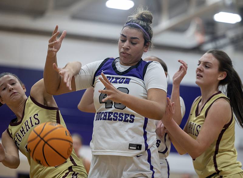 Dixon's Hallie Williamson battles with Morris for the ball Friday, Jan. 3, 2025, at Dixon High School.