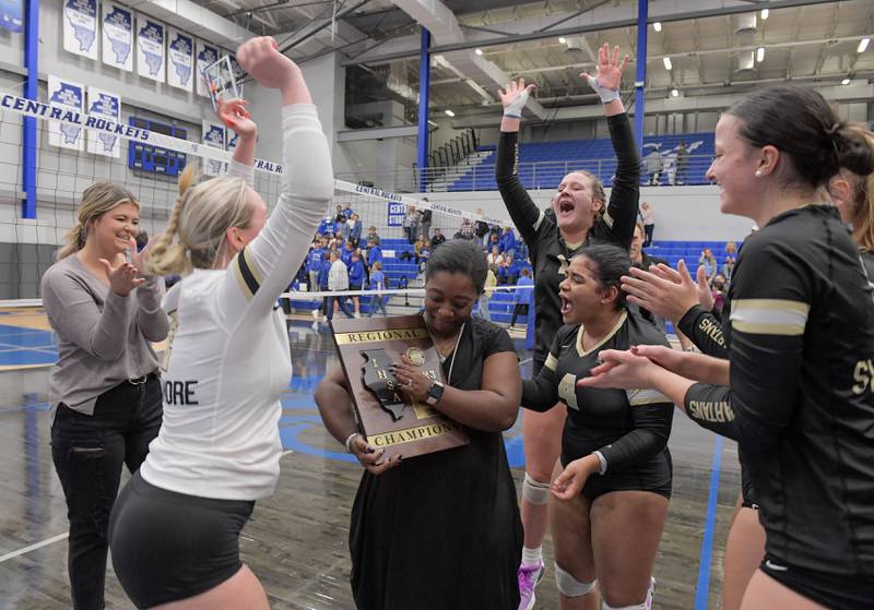 Sycamore celebrates winning the Class 3A Burlington Central Girls Volleyball Regional over Central with Sycamore head coach Jennifer Charles on Thursday, Oct. 26, 2023.