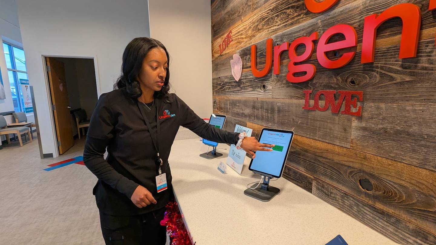 Deja Finner, senior assistant at UrgentVet Joliet, demonstrates the check-in process at UrgentVet Joliet on Friday, Feb. 7, 2025.