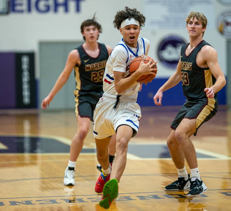 Marmion's Jabe Haith (2) drives to the basket past Morris’ Jonah Williams (33) and Brett Bounds (25) during the 59th Annual Plano Christmas Classic basketball tournament at Plano High School on Tuesday, Dec 27, 2022.