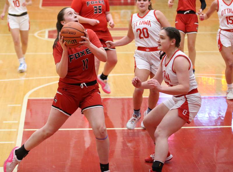 Yorkville's Brooke Spychalski looks at the hoop as Ottawa's Mary Stisser defends on Monday, Dec. 4, 2023 at Kingman Gym.