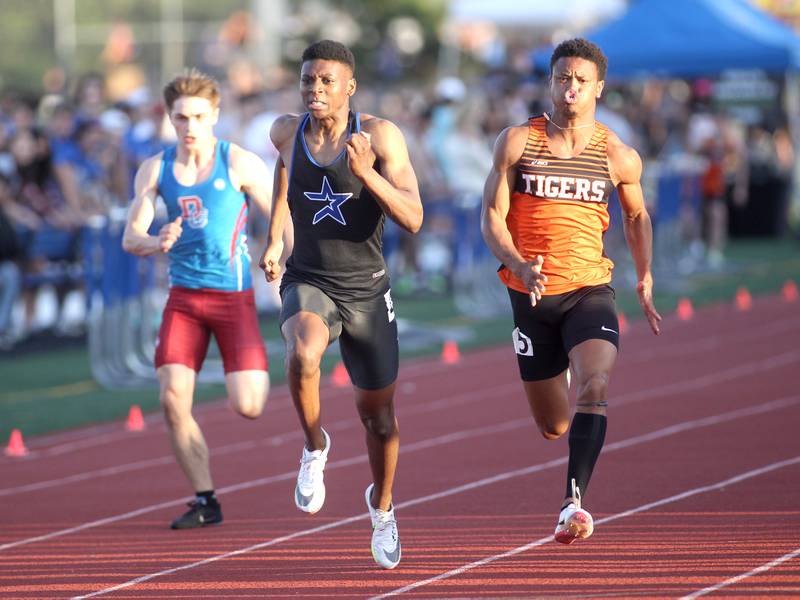 St. Charles North’s Joshua Duncan (center) ties the state record in the 100-meter dash followed by Dundee-Crown’s Henry Kennedy and Wheaton Warrenville South’s Reece Young.