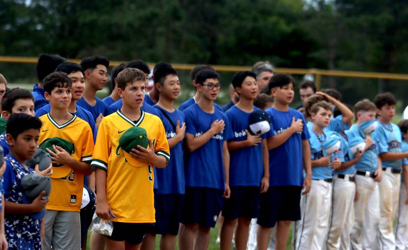 Players observe the playing of the national anthem during MCYSA 2023 Summer International Championships Opening Ceremonies Friday, June 14, 2023, at the Mickey Sund Complex in Lippold Park in Crystal Lake.