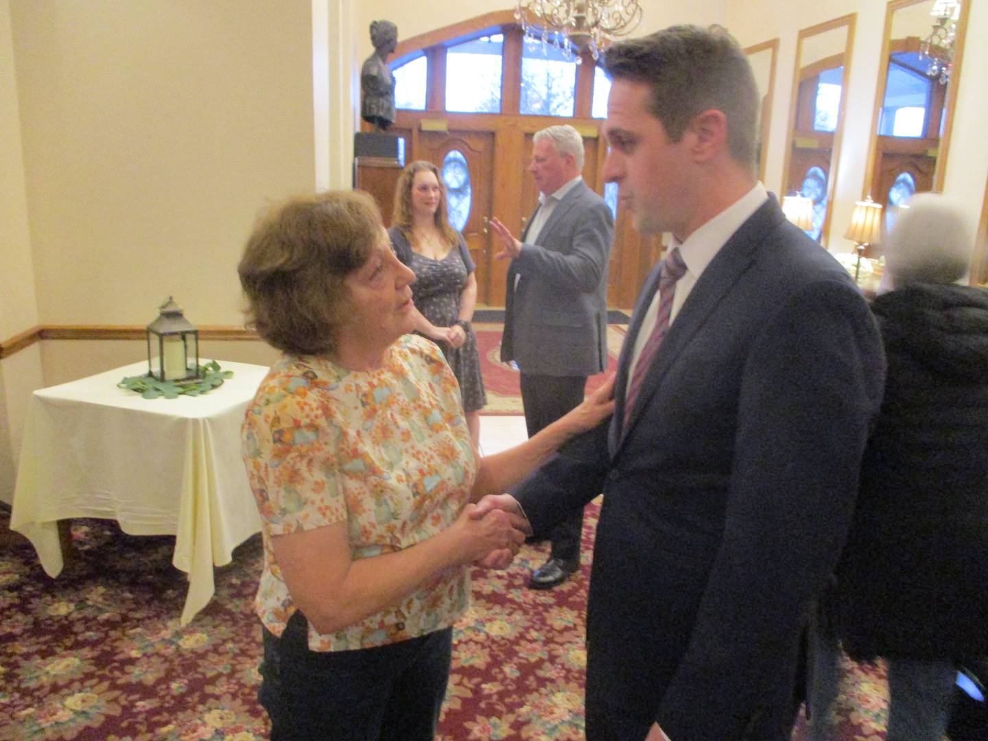 Joliet Township supervisor candidate Darrell Boisdorf talks with Rita Slattery before the start of a candidates' forum on Wednesday at the Jacob Henry Mansion Estate in Joliet. March 19, 2025