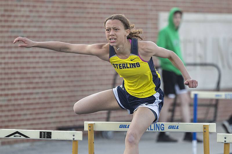 Sterling’s Anessa Johnson clears the final hurdle in the 100 shuttle hurdles Thursday, April 27, 2023 at the Sterling Night Relays.