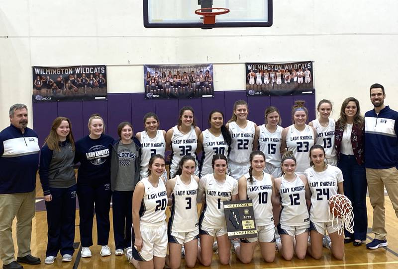The Fieldcrest girls basketball team poses with its newly won Class 2A Wilmington Regional championship plaque Thursday, Feb. 16, 2023.