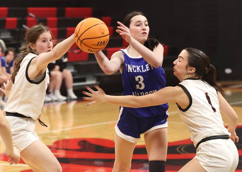 Hinckley-Big Rock's Mia Cotton passes the ball over Indian Creek's Riley Wilson during their game Monday, Jan. 13, 2025, at Indian Creek High School in Shabbona.