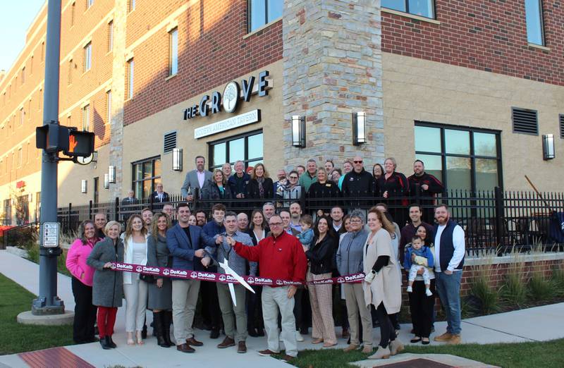 The DeKalb Chamber of Commerce welcoming Agora Tower, The Grove - Modern American Tavern, and State Farm Insurance - Brian Scholle with a ribbon-cutting