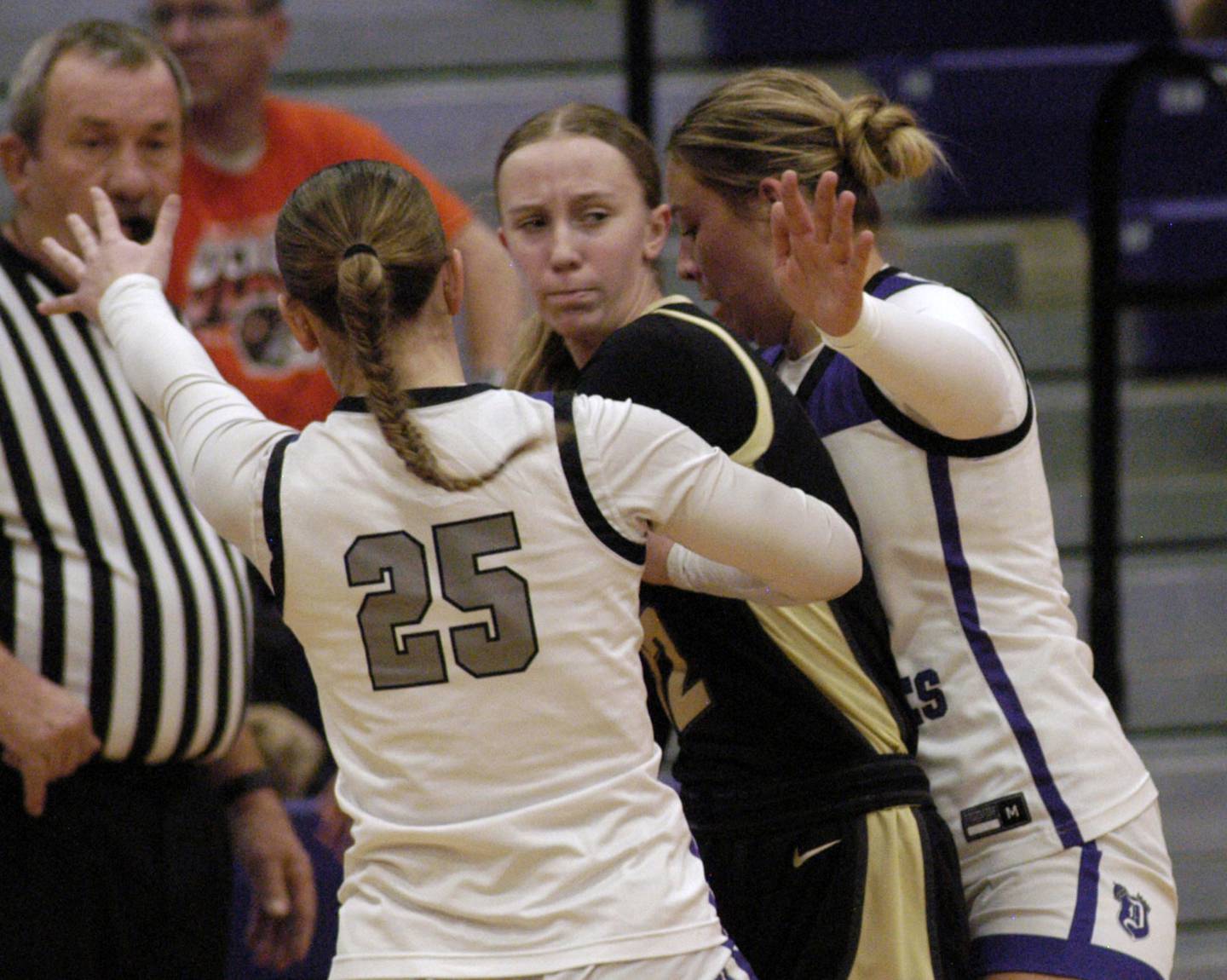 Sycamore's Sadie Lang is surrounded by Dixon's Presley Lapin and Abby Hicks. The Dixon Duchesses beat the Sycamore Spartans 55-47 in a non-conference game played at Lancaster Gym in Dixon on Saturday, December 20th, 2025.