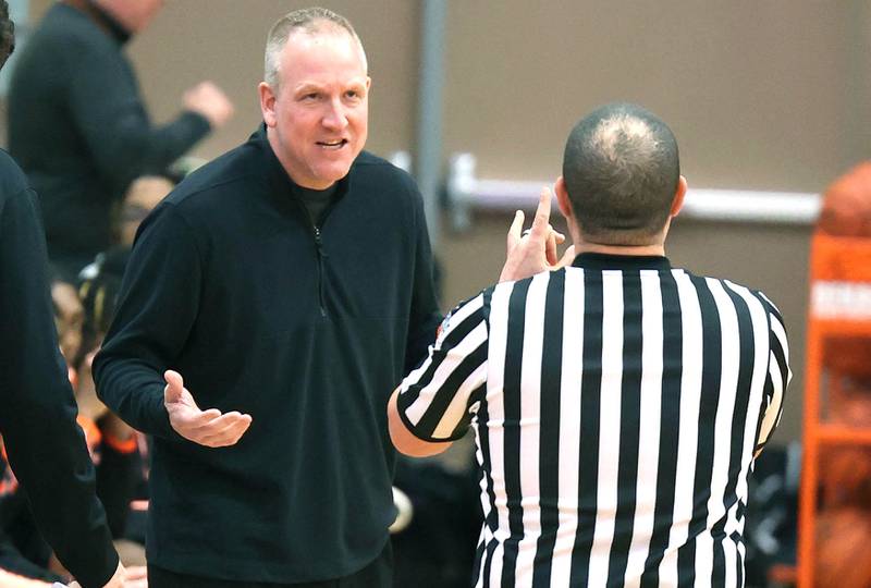 DeKalb head coach Mike Reynolds talks to an official during their game against Naperville North Monday, Jan. 30, 2023, at DeKalb High School.
