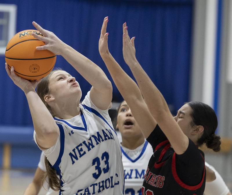 Newman’s Veronica Haley works below the basket against Erie-Prophetstown’s Ava Grawe Thursday, Jan. 29, 2026.