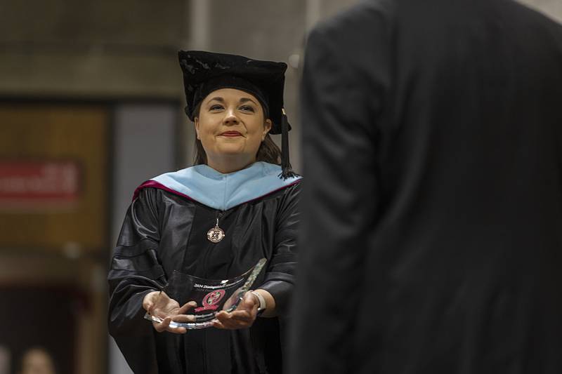 Dr. Lori Cortez awards Bob Sondgeroth the Distinguished Alumnus award Friday, May 10, 2024 during Sauk Valley College’s 2024 commencement ceremony.