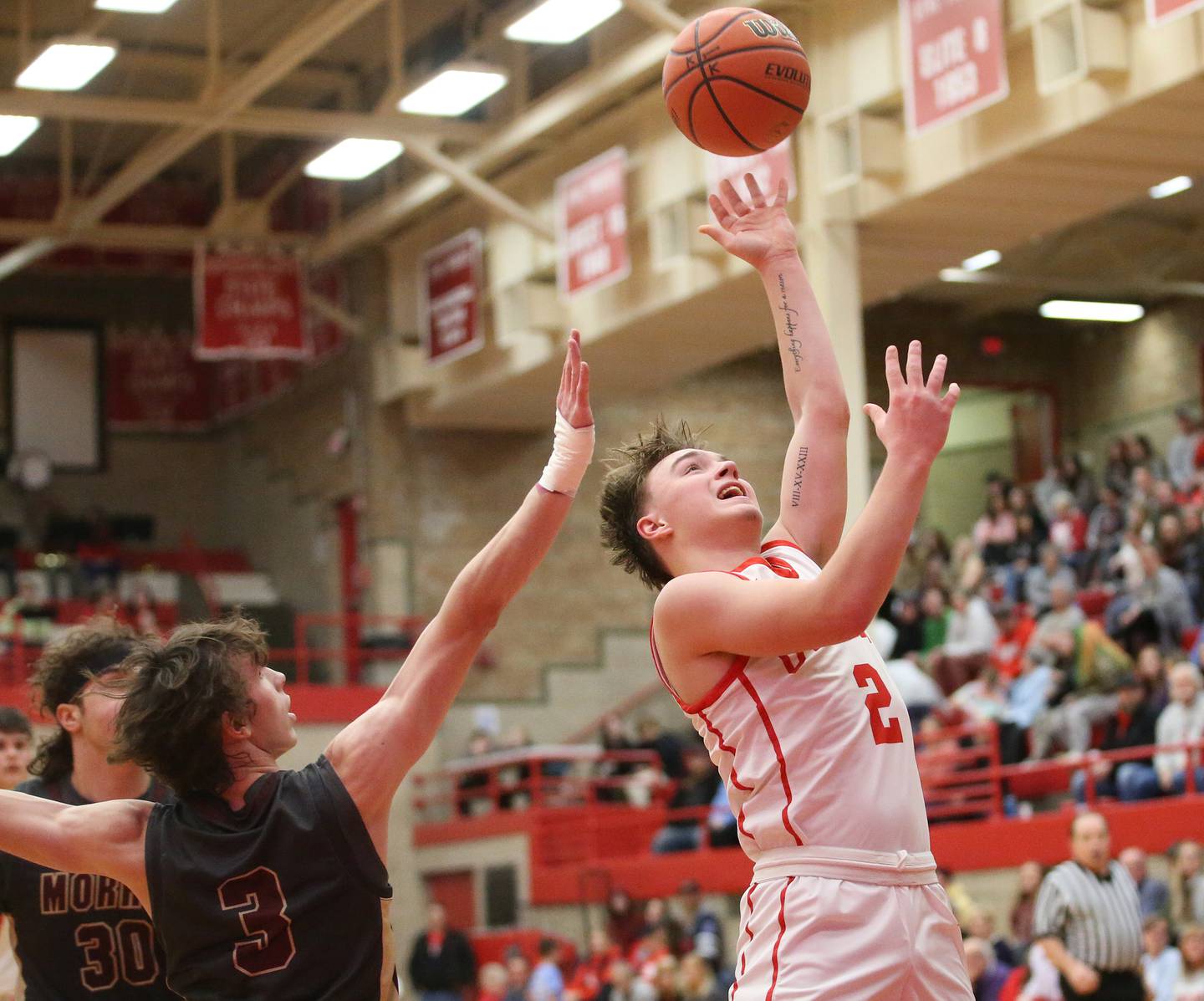 Ottawa's Huston Hart runs in the lane to score on a layup against Morris's Caston Norris on Wednesday, Jan. 3, 2024 at Kingman Gym.